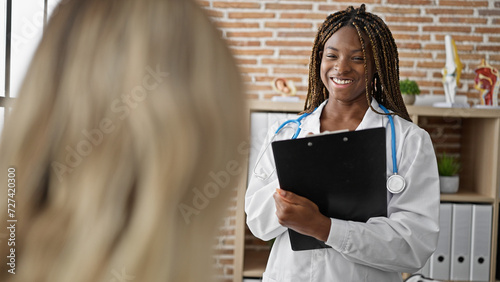 African american woman doctor having medical consultation with patient at the clinic photo