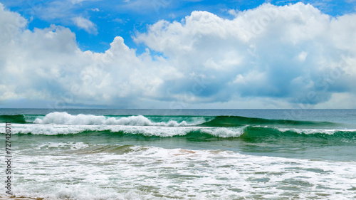tropical beach and sky with beautiful cumulus clouds. Wide photo.