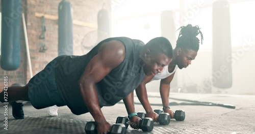 Push up, strong or men with dumbbells in gym training, exercise or workout for fitness development. Black people, healthy athletes or African bodybuilders with weights for cardio or biceps muscle photo
