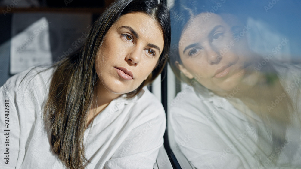 Young beautiful hispanic woman thinking looking through the window inside train wagon Young beautiful hispanic woman thinking looking through the window inside train wagon