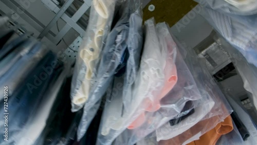 Clean clothes on the conveyor in dry cleanerr