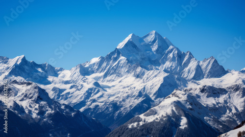 Majestic Mountain Range Covered in Snow Under a Blue Sky