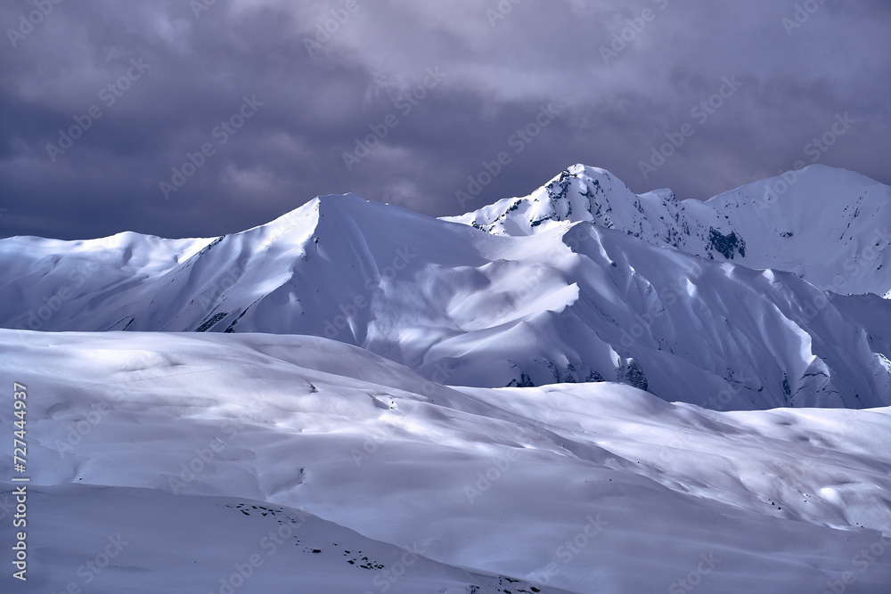 Breathtaking beautiful panoramic view on Snow Alps - snow-capped winter mountain peaks around French Alps mountains, The Three Valleys: Courchevel, Val Thorens, Meribel (Les Trois Vallees), France