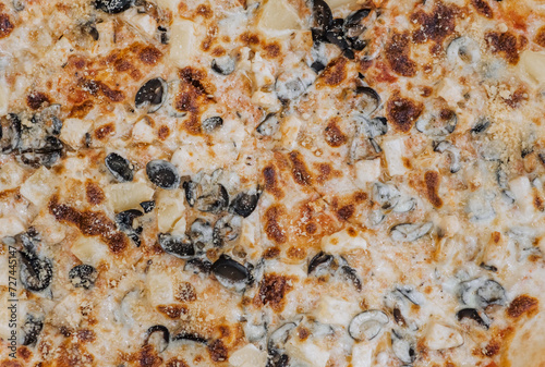 Top view of pieces of ingredients in fresh hot delicious Italian pizza. Close-up photography of food.