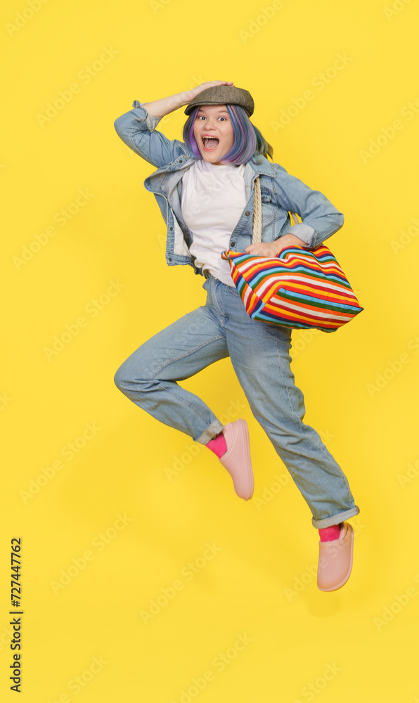 Shopping For Children And Teenagers, Happy Girl Jumps With Bag Full Of Toys And Goods. Isolated Against Yellow Background, Successful Shopping Spree For Playful Items. High quality photo Shopping For Children And Teenagers, Happy Girl Jumps With Bag Full Of Toys And Goods. Isolated Against Yellow Background, Successful Shopping Spree For Playful Items. High quality photo