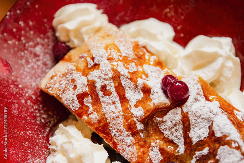 Classic Apple Strudel with Cream and Cranberries photo