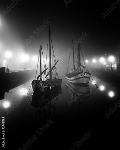 Boats that surface in the fog photo