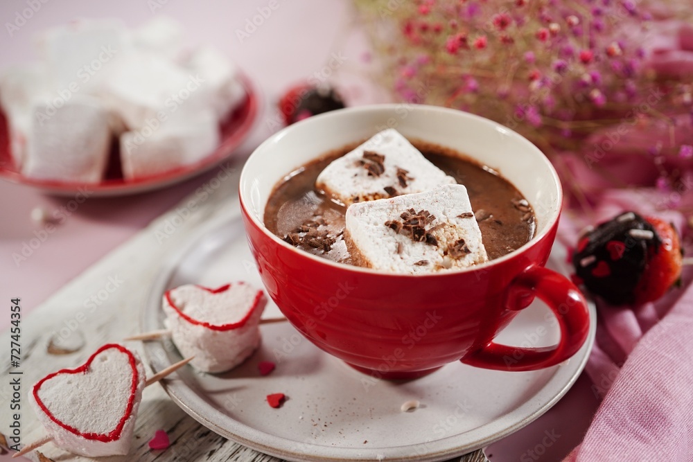 Valentines day hot chocolate or cocoa with homemade heart marshmallows on pink background Valentines day hot chocolate or cocoa with homemade heart marshmallows on pink background