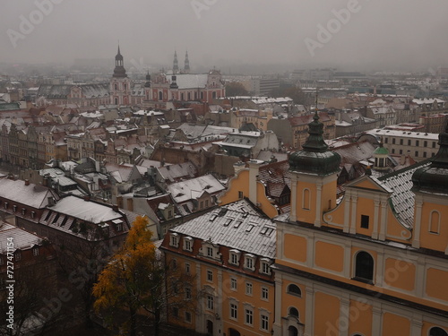 View of Poznan Poland on a snowy November day with the roofs of old houses and steeples of catholic churches