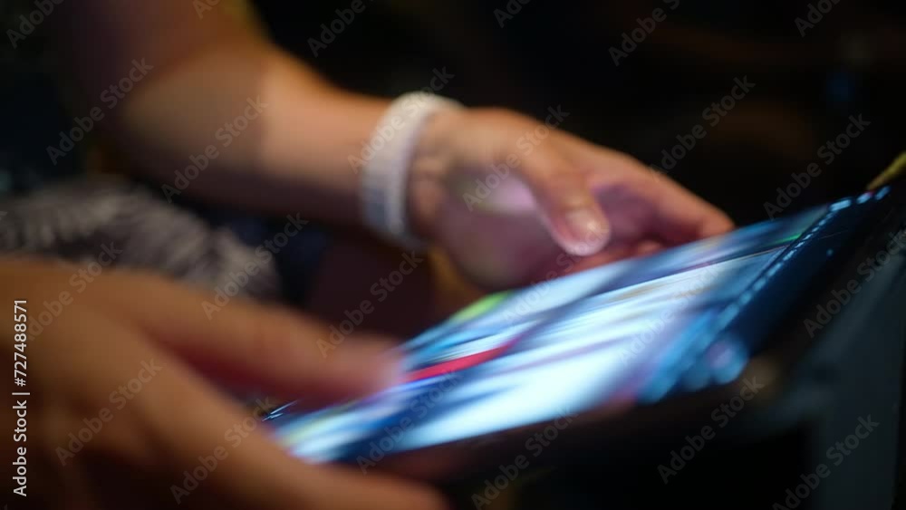 Young man scrolling content online, wireless internet. Closeup male hands searching on tablet screen, browsing videos or image content using WiFi at night. Close view modern tech device bright screen Young man scrolling content online, wireless internet. Closeup male hands searching on tablet screen, browsing videos or image content using WiFi at night. Close view modern tech device bright screen