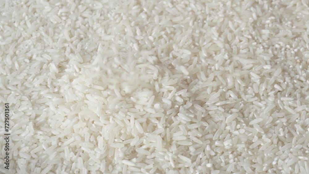Raw rice grains fall. Pouring rice close up. Asian traditional food. Healthy ingredient