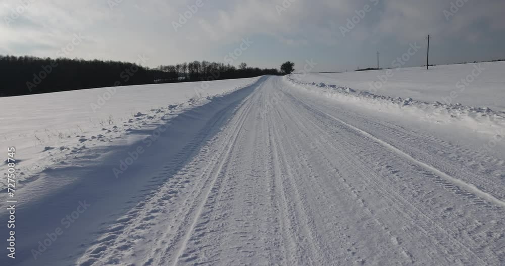 winter road after snowfall in sunny weather, the highway in the snow is illuminated by sunlight winter road after snowfall in sunny weather, the highway in the snow is illuminated by sunlight