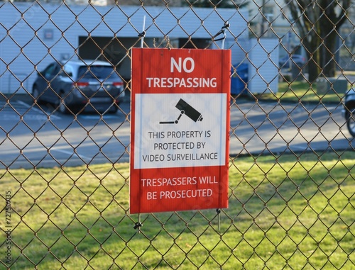 no trespassing danger sign on chainlink fence DSLR photo 