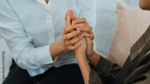 Supportive and comforting hands cheering up depressed patient person or stressed mind with empathy. Psychologist reassuring stressful and sad patient in vivancy clinic. © Summit Art Creations