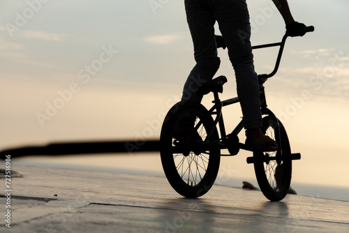 Freestyle cyclist practicing street BMX
