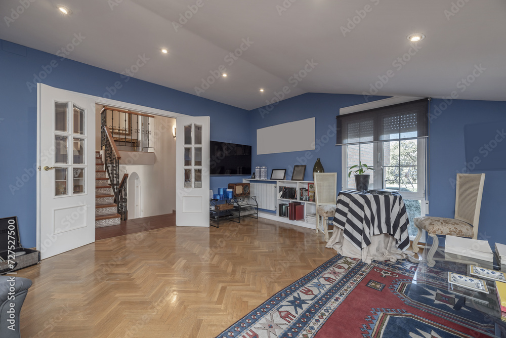 Fototapeta premium living room of a house with blue painted walls, white carpentry
