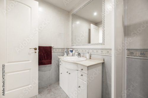 Fototapeta Naklejka Na Ścianę i Meble -  Bathroom with white furniture, square shower cabin, white toilets, white access door, stoneware floors