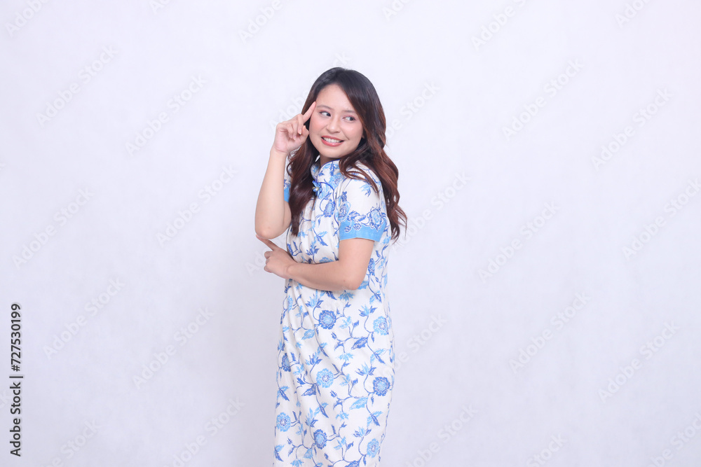 beautiful cheerful chinese woman wearing modern chinese dress hand marked thinking lyrics left on white background. happy Chinese New Year beautiful cheerful chinese woman wearing modern chinese dress hand marked thinking lyrics left on white background. happy Chinese New Year