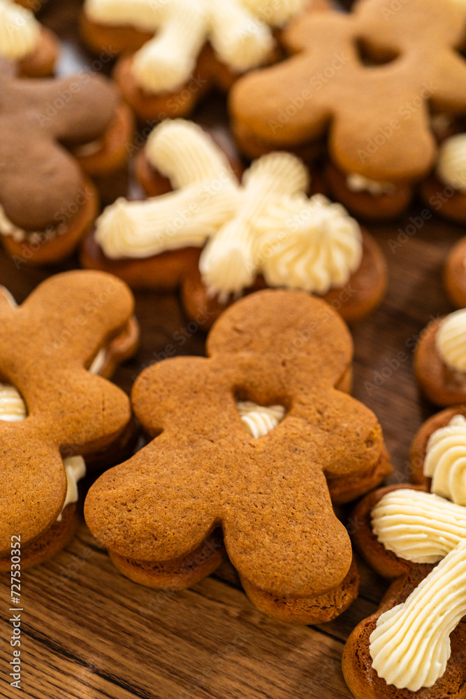 Fototapeta premium Making Festive Gingerbread Sandwiches on Rustic Wooden Table
