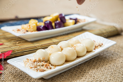 Taiwanese traditional sweet and dessert, glutinous rice dumplings and sweet potato dumplings with coconut sugar and peanuts and coconut flakes