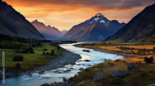 Majestic mountain range with serpentine river, dusk lighting