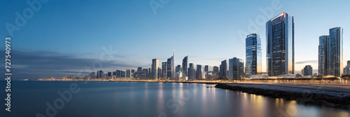 Modern buildings, lights, and the skyline of a city, showcasing an urban atmosphere. 3:1 landscape banner and background style. Space for text. Suitable for website headers or background images.