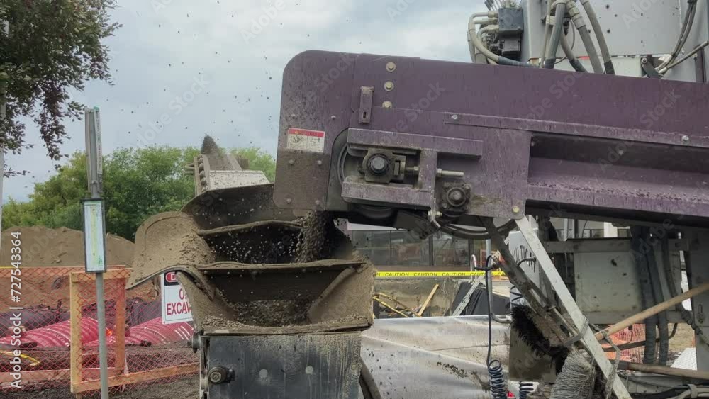 Focused Detail: Slinger Conveyor Belt in Action, Propelling Rocks for Gas Station Tank Backfilling Focused Detail: Slinger Conveyor Belt in Action, Propelling Rocks for Gas Station Tank Backfilling