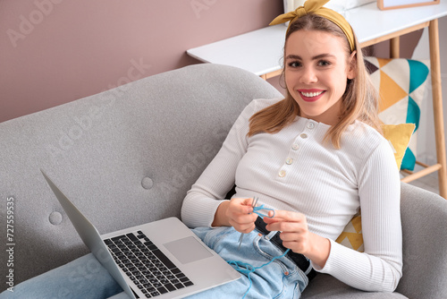 Young woman knitting with n...