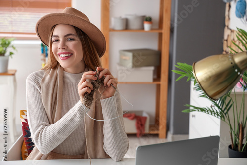 Young woman knitting with n...