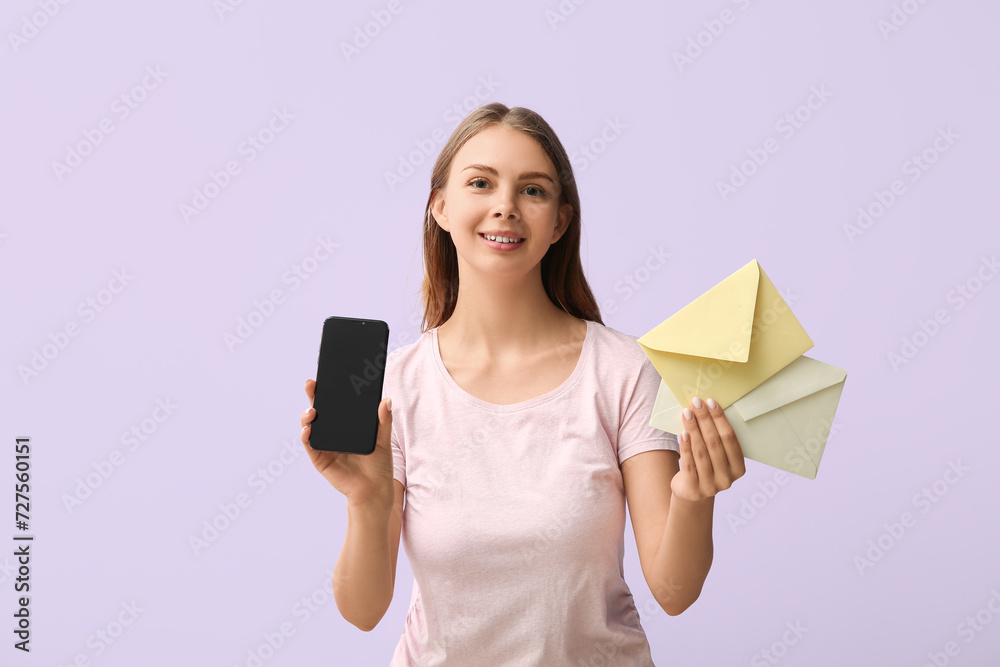 Pretty young woman with mobile phone and envelopes on lilac background Pretty young woman with mobile phone and envelopes on lilac background