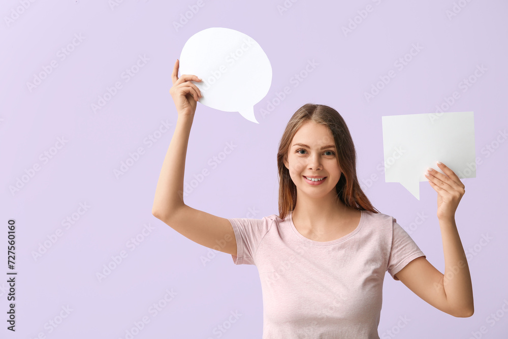 Pretty young woman holding blank speech bubbles on lilac background Pretty young woman holding blank speech bubbles on lilac background