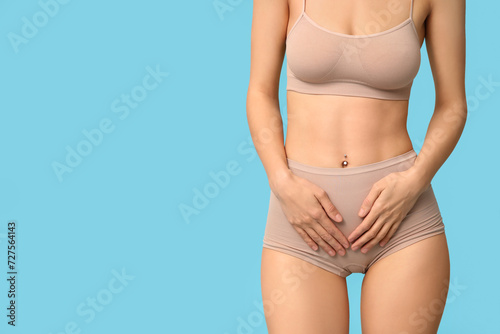 Beautiful young woman in underwear on blue background © Pixel-Shot