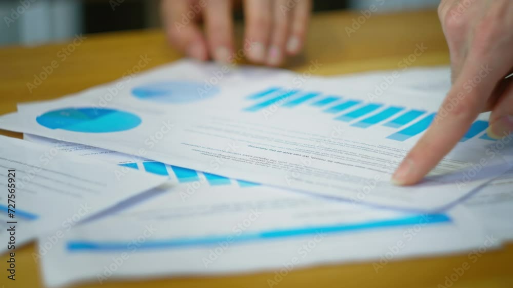 Business people analyzing charts information on documents, using papers to create report analysis, team working on statistical data
