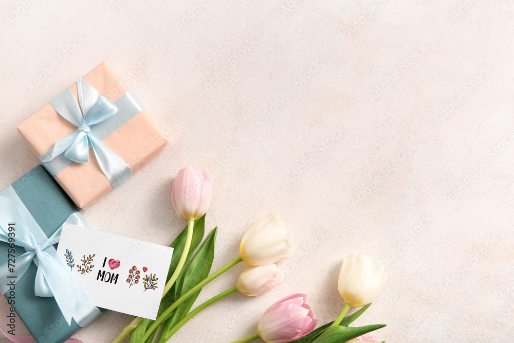Greeting card, gift boxes and tulip flowers for Mother's Day celebration on light background Greeting card, gift boxes and tulip flowers for Mother's Day celebration on light background
