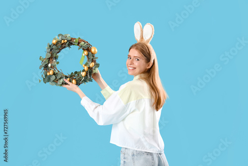 Young woman in bunny ears w...