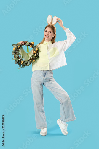 Young woman in bunny ears w...