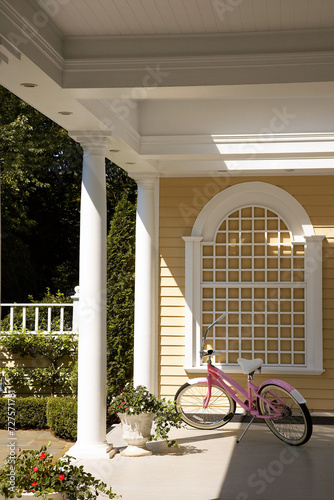 Front porch with my old fashioned pink bicycle already for a fun bike ride in summer photo