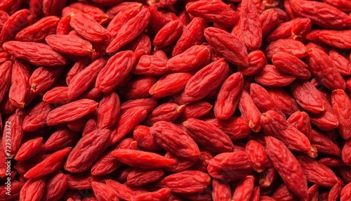 A pile of red berries, possibly raspberries, in a close up shot