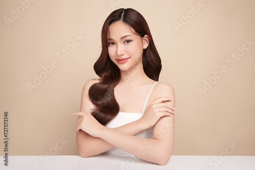 Beautiful young woman with clean fresh skin on beige background, Face care, Facial treatment, Cosmetology, beauty and spa, women portrait.