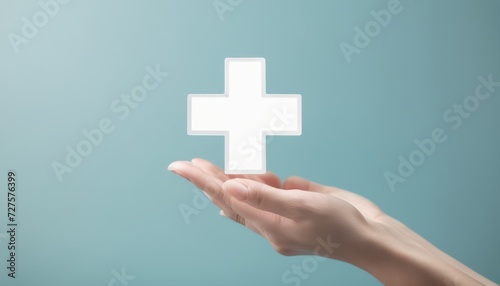 A hand holding a cross