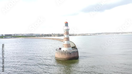 Drone footage of lighthouse of Roker pier with seascape view on a sunny bright day in Sunderland photo