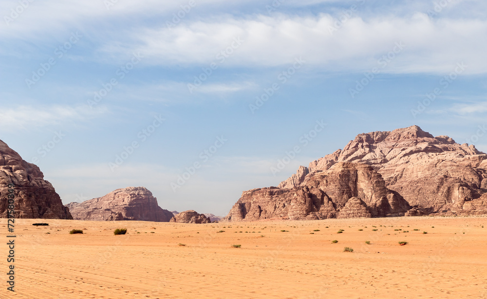 Unique beauty of high mountains in endless sandy red desert of Wadi Rum near Amman in Jordan