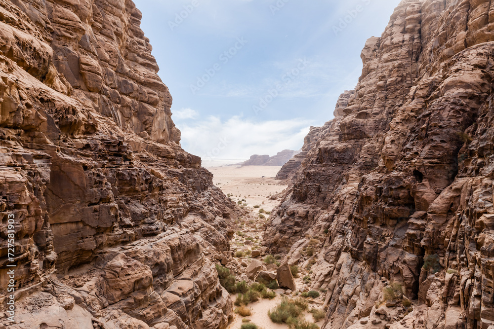 A beautiful gorge framed by high mountains in the red desert of Wadi Rum near Amman in Jordan