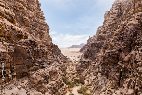 A beautiful gorge framed by high mountains in the red desert of Wadi Rum near Amman in Jordan