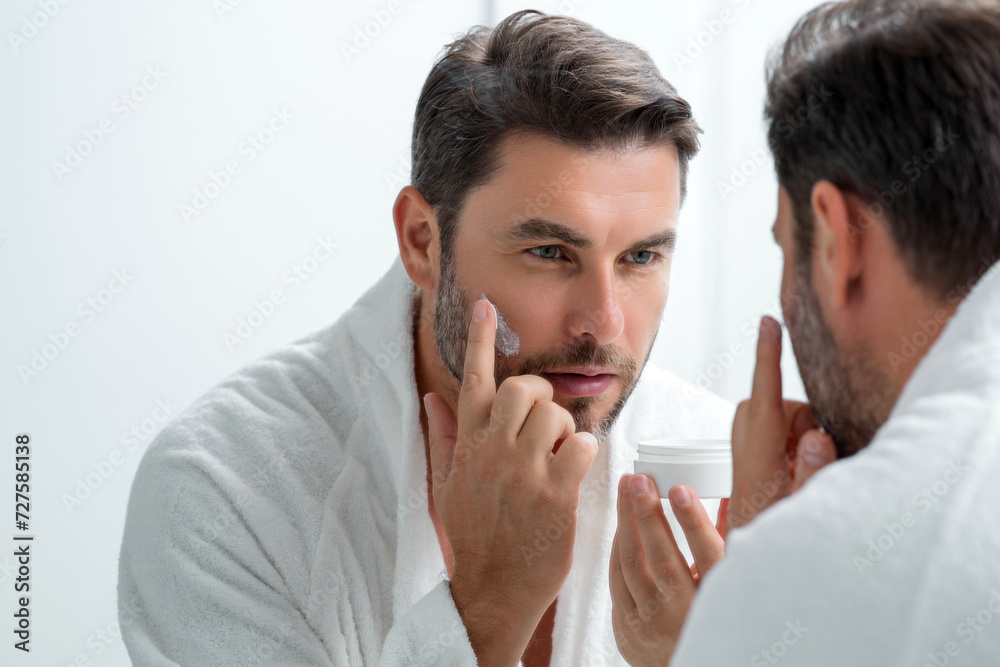 Beauty man applying face cream. Skincare cream, skin anti-aging wrinkle effect. Man applying moisturizer cream on skin. Skin care, cosmetic cream treatment for male face. Male skin care beauty. Beauty man applying face cream. Skincare cream, skin anti-aging wrinkle effect. Man applying moisturizer cream on skin. Skin care, cosmetic cream treatment for male face. Male skin care beauty.