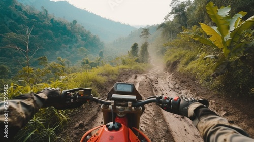 Fototapeta Naklejka Na Ścianę i Meble -  First-person view of riding a motorcycle on a muddy jungle path