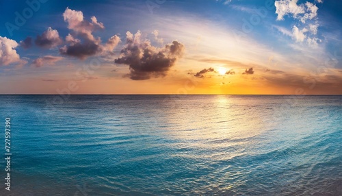 sunset over the ocean, calm ocean at dawn or sunset. Panoramic banner of a peaceful landscape