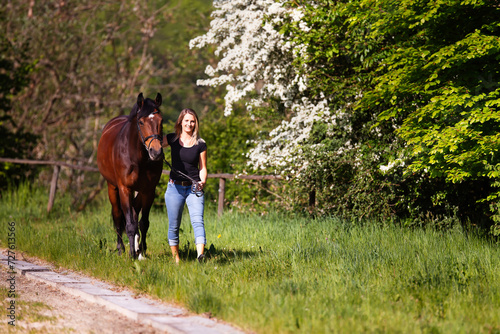Young woman with horse in spring in nature. © RD-Fotografie