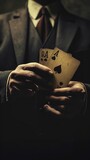 Man in a suit holding four playing cards