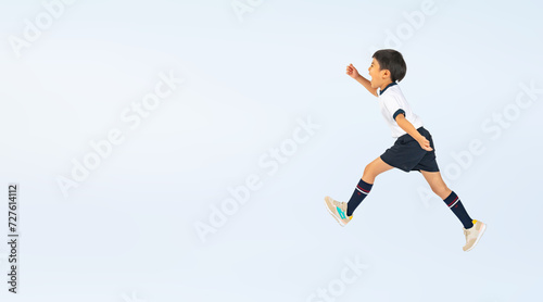 ジャンプする体操服を着た男の子（切り抜き背景透過PNGも販売しております。作成者リンクから「PNG」で検索してください） photo